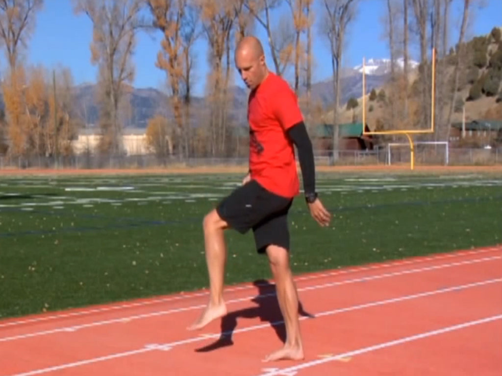 Runner training on the B2R Slant Wobble Board on a running track